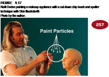 Подпись: FIGURE 9.17 Neill Gorton painting a makeup appliance with a cut-down chip brush and spatter technique with Skin Illustrator®. Photo by the author. 